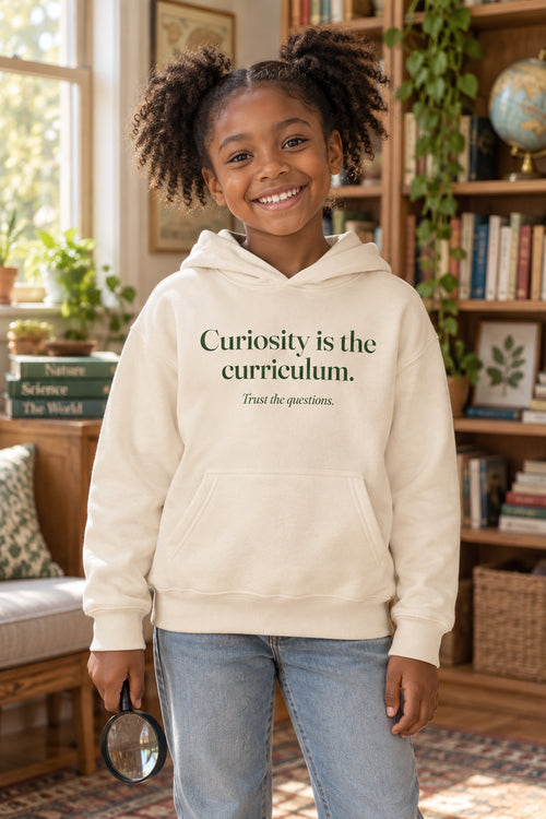Curiosity is the curriculum. kids hoodie in Ivory, front