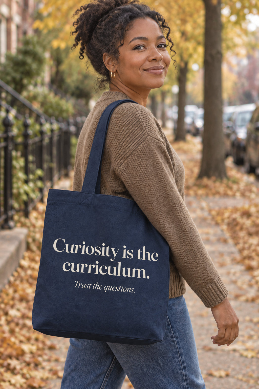 Curiosity is the curriculum. organic canvas market tote in Navy, carried on the shoulder