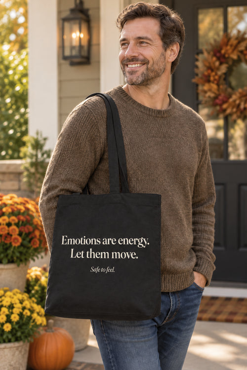 Emotions are energy. Let them move. organic canvas market tote in Black, carried on the shoulder