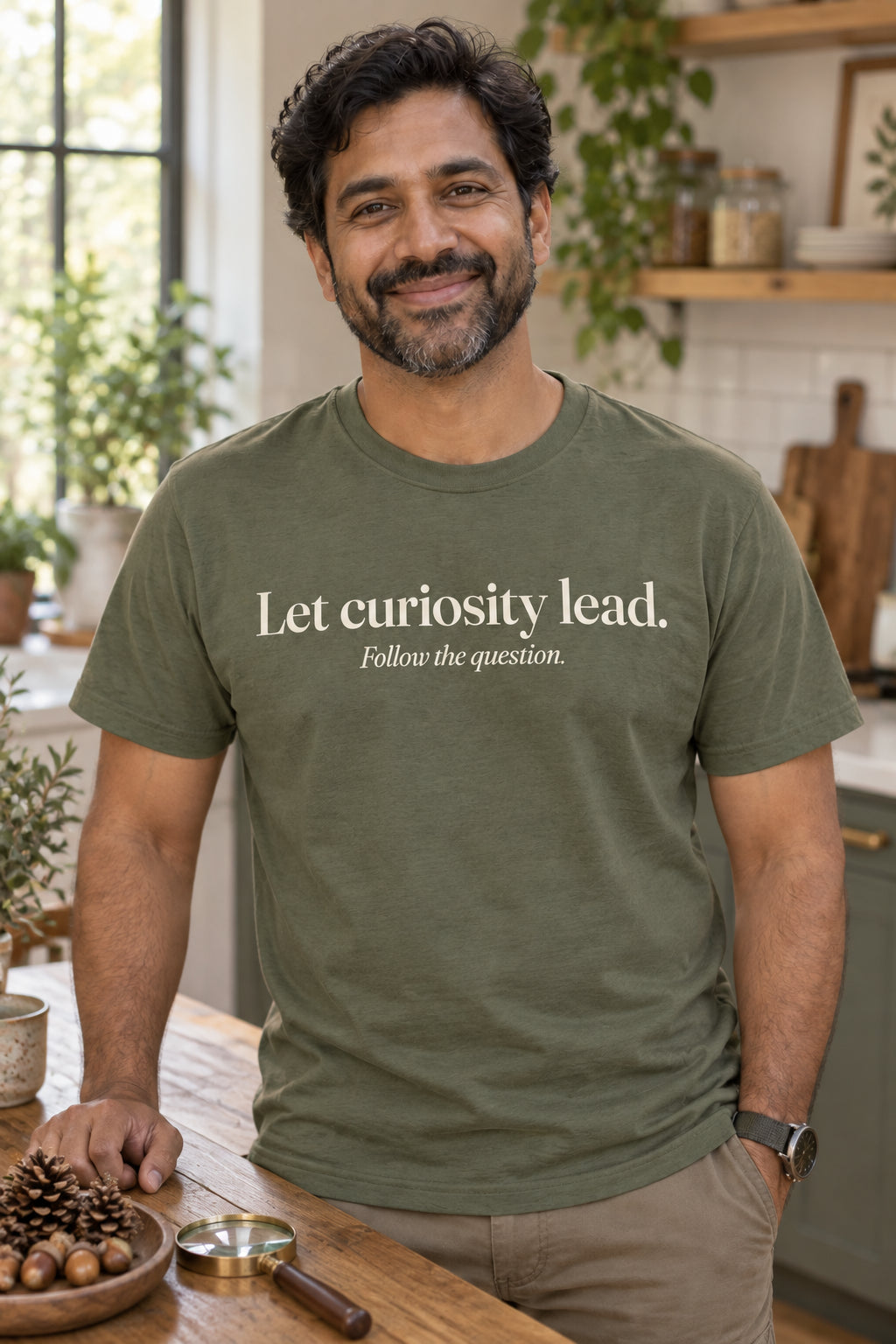 Let curiosity lead. unisex organic cotton tee in Moss, front
