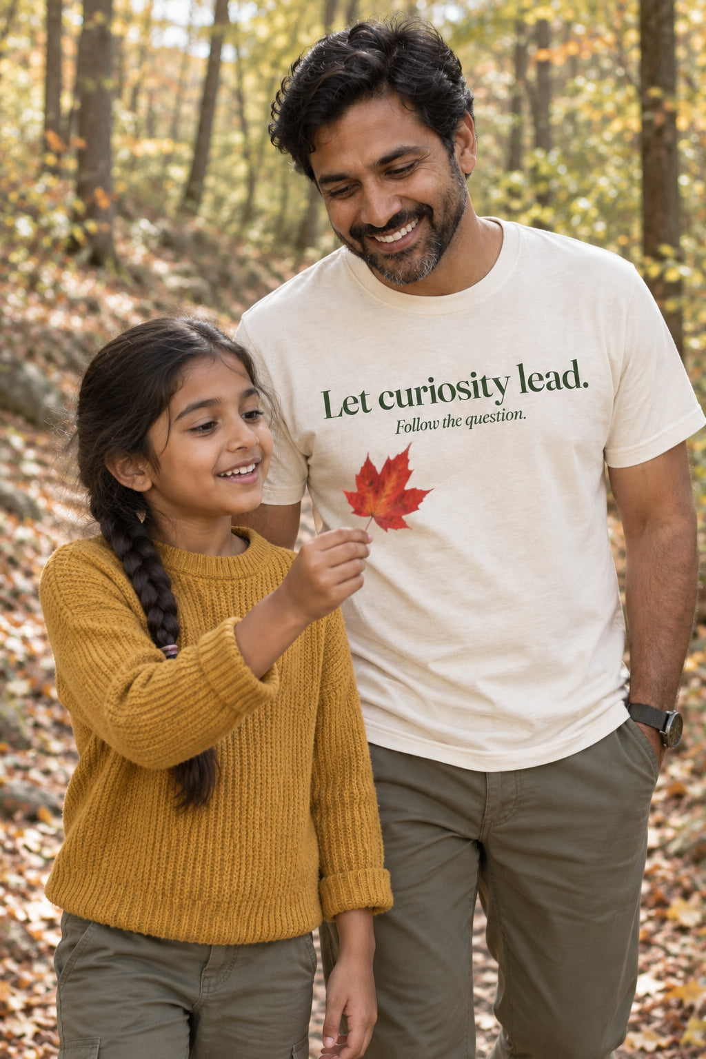 Parent wearing the Let curiosity lead. adult tee in Natural
