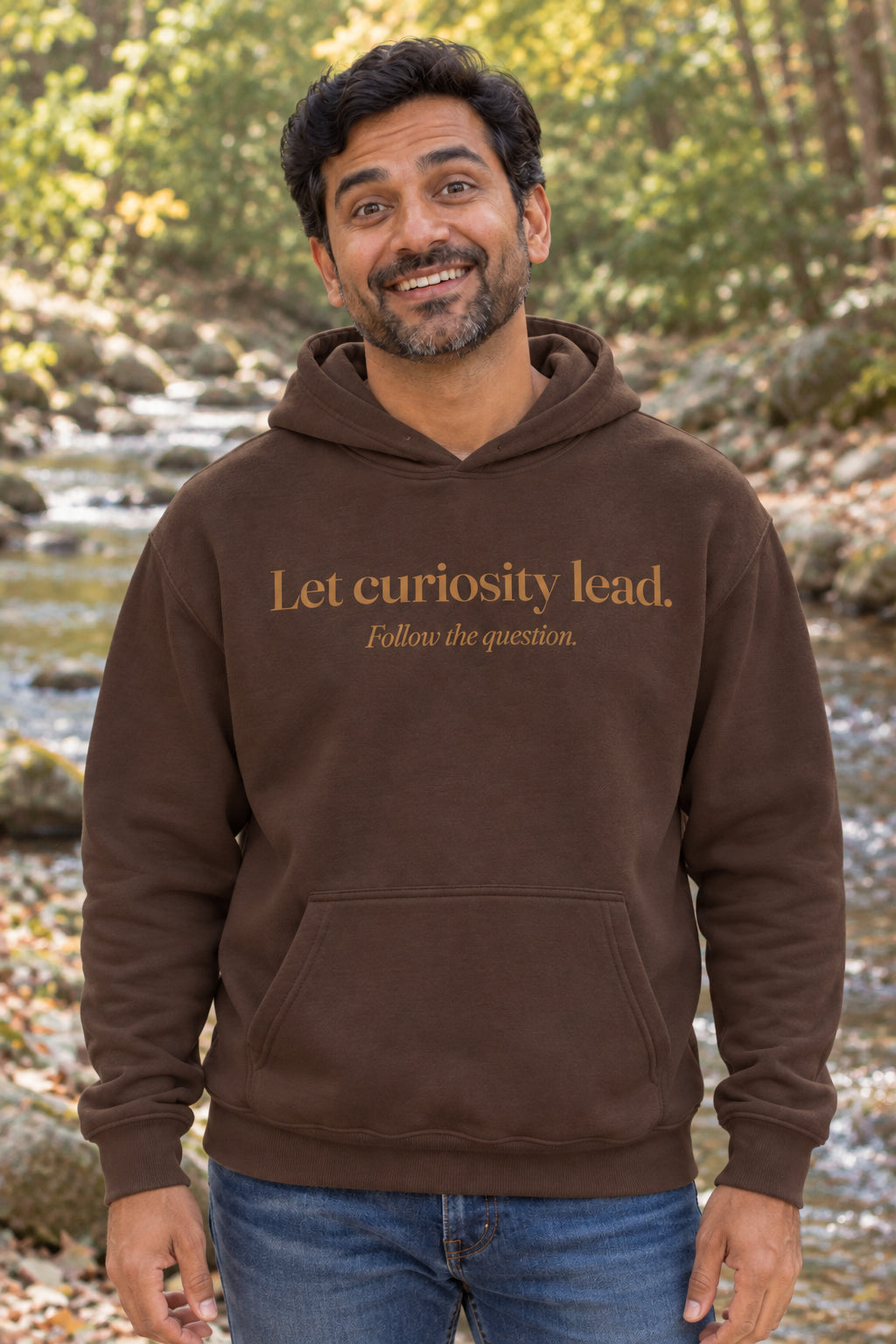 Let curiosity lead. unisex organic cotton hoodie in Bark, front
