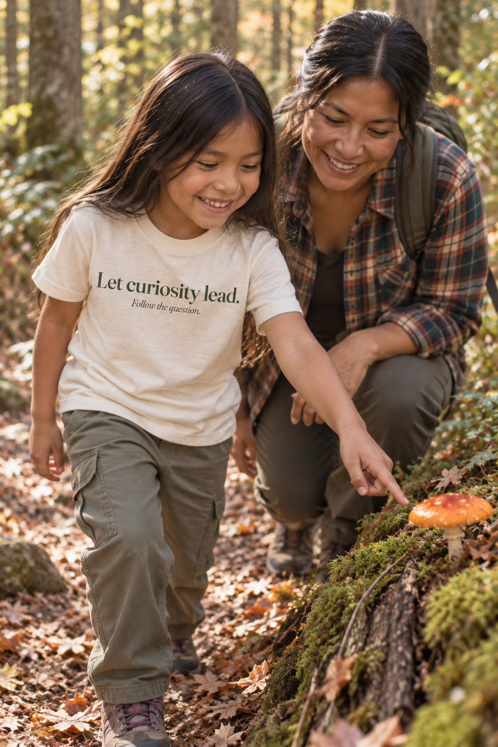 Child wearing the Let curiosity lead. kids tee in Natural