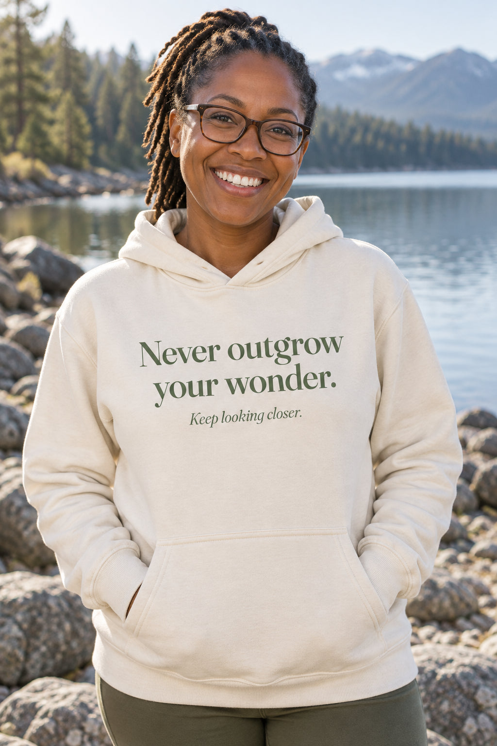 Never outgrow your wonder. unisex organic cotton hoodie in Natural, front