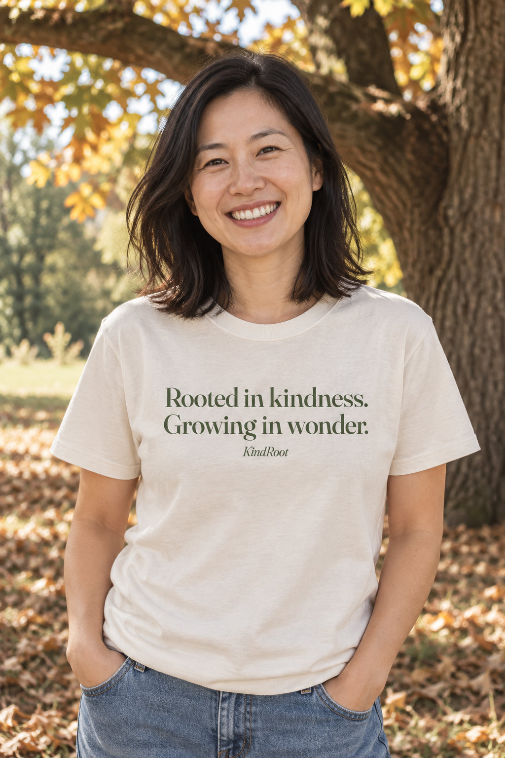 Rooted in kindness. Growing in wonder. unisex organic cotton tee in Natural, front
