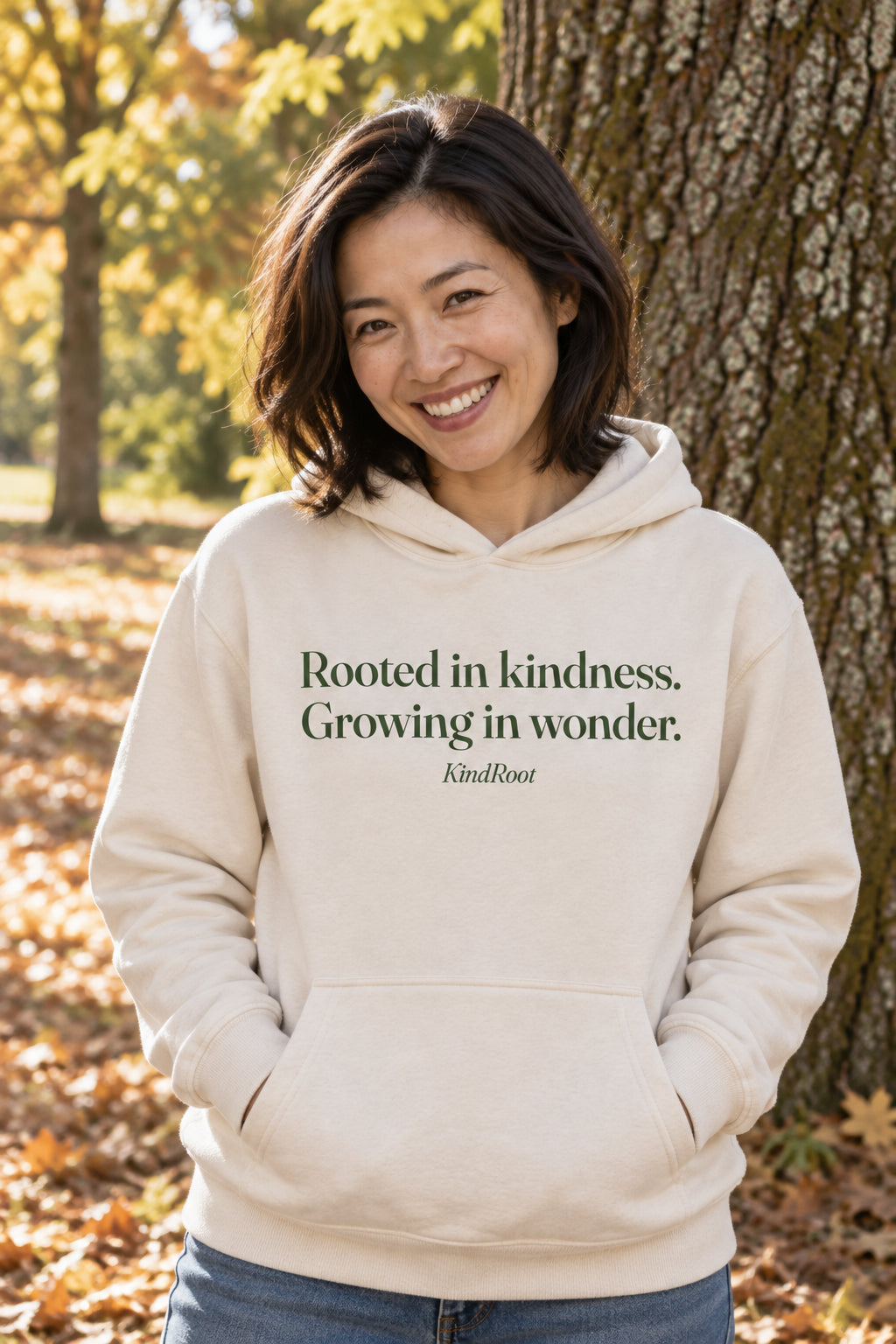 Rooted in kindness. Growing in wonder. unisex organic cotton hoodie in Natural, front