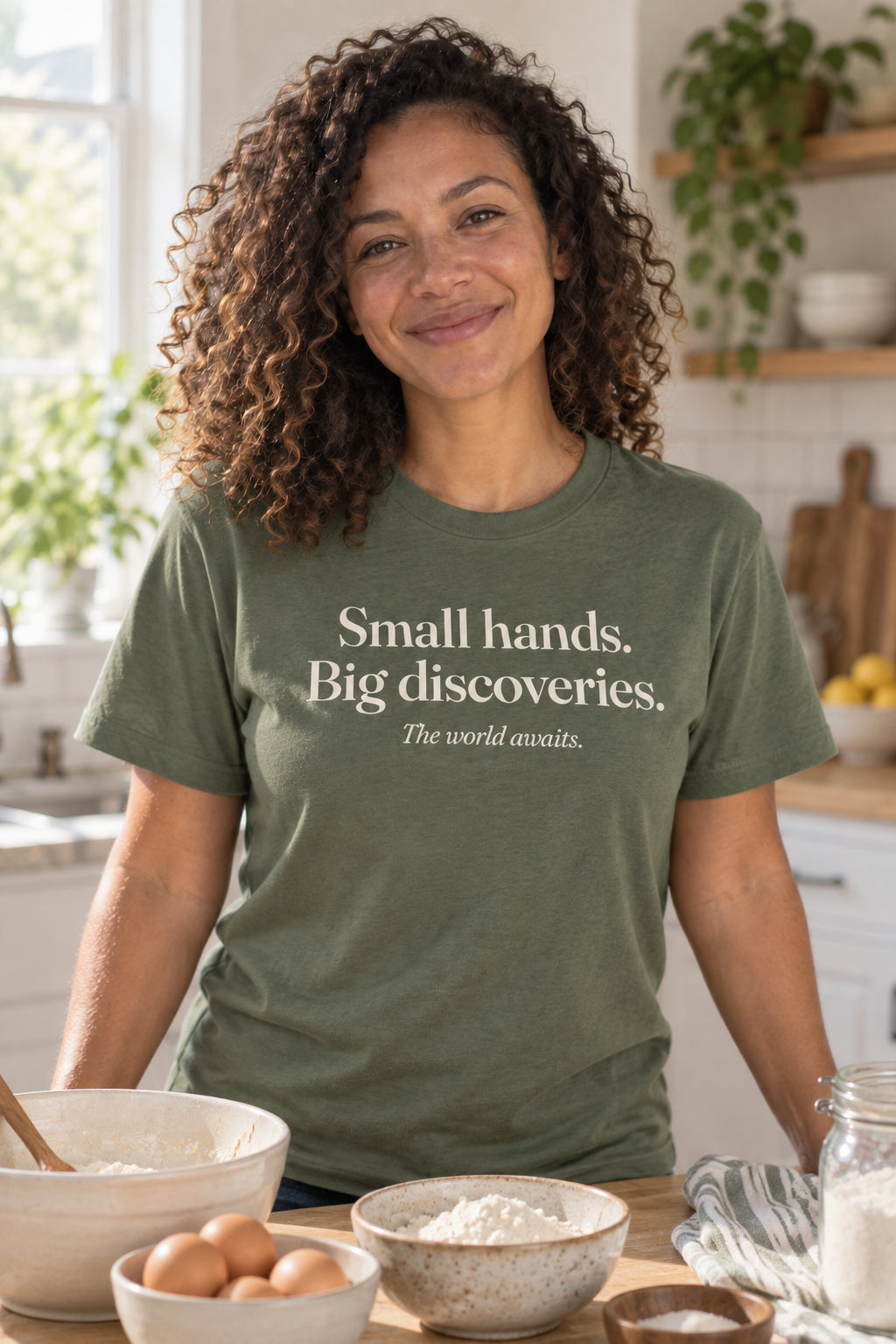Small hands. Big discoveries. unisex organic cotton tee in Moss, front
