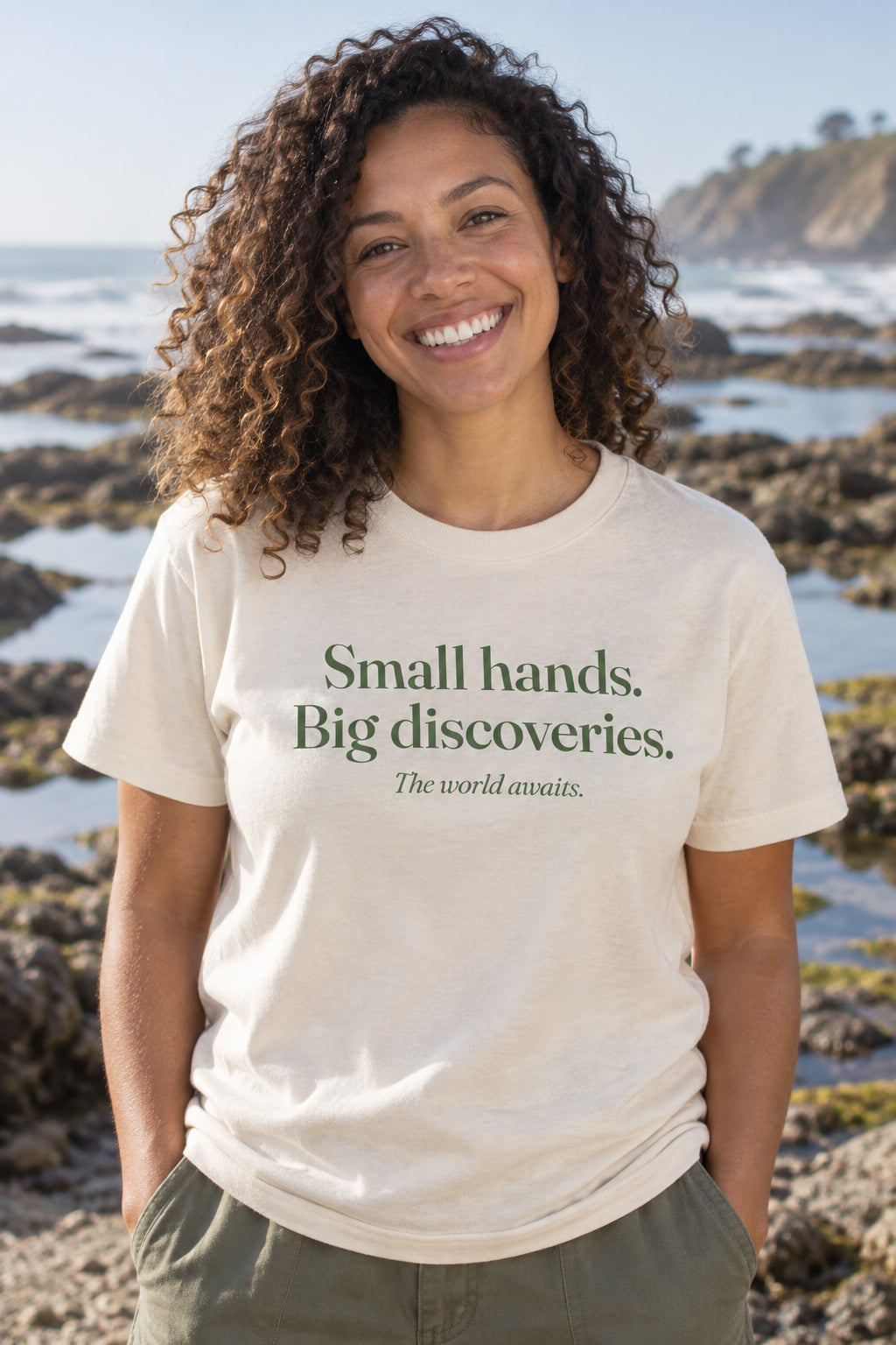 Small hands. Big discoveries. unisex organic cotton tee in Natural, front
